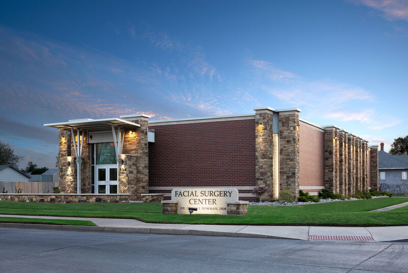 Exterior front of Facial Surgery Center in Enid during twilight with brick and stone