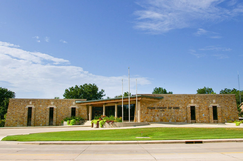 Exterior of Farm Credit of Enid with stone façade and glass entry